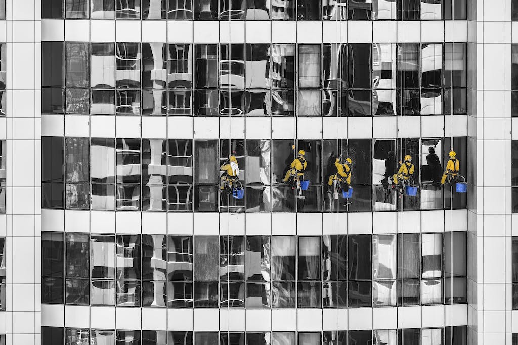 Five Person Cleaning Glass Building